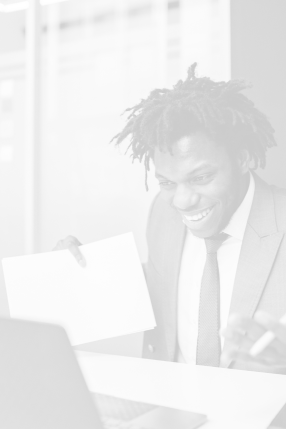 A person in a suit looking at a laptop