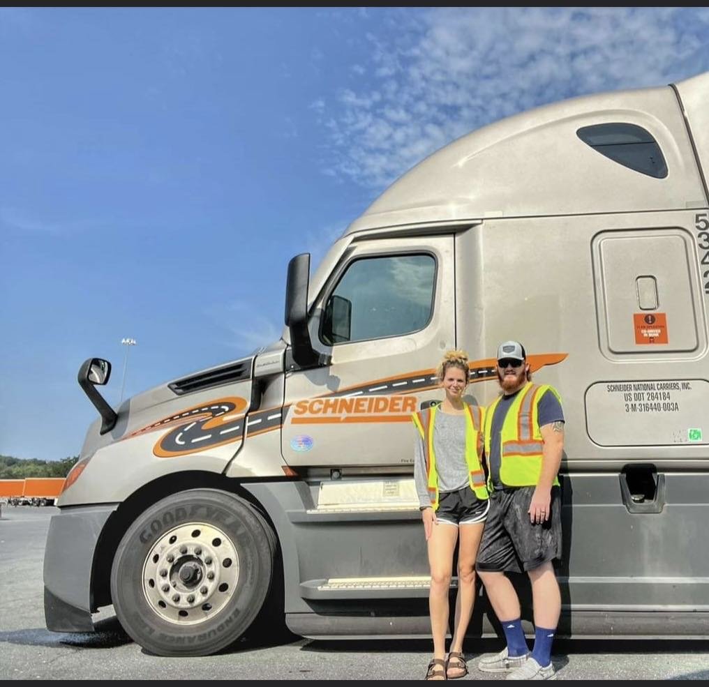 a person and person standing next to a truck