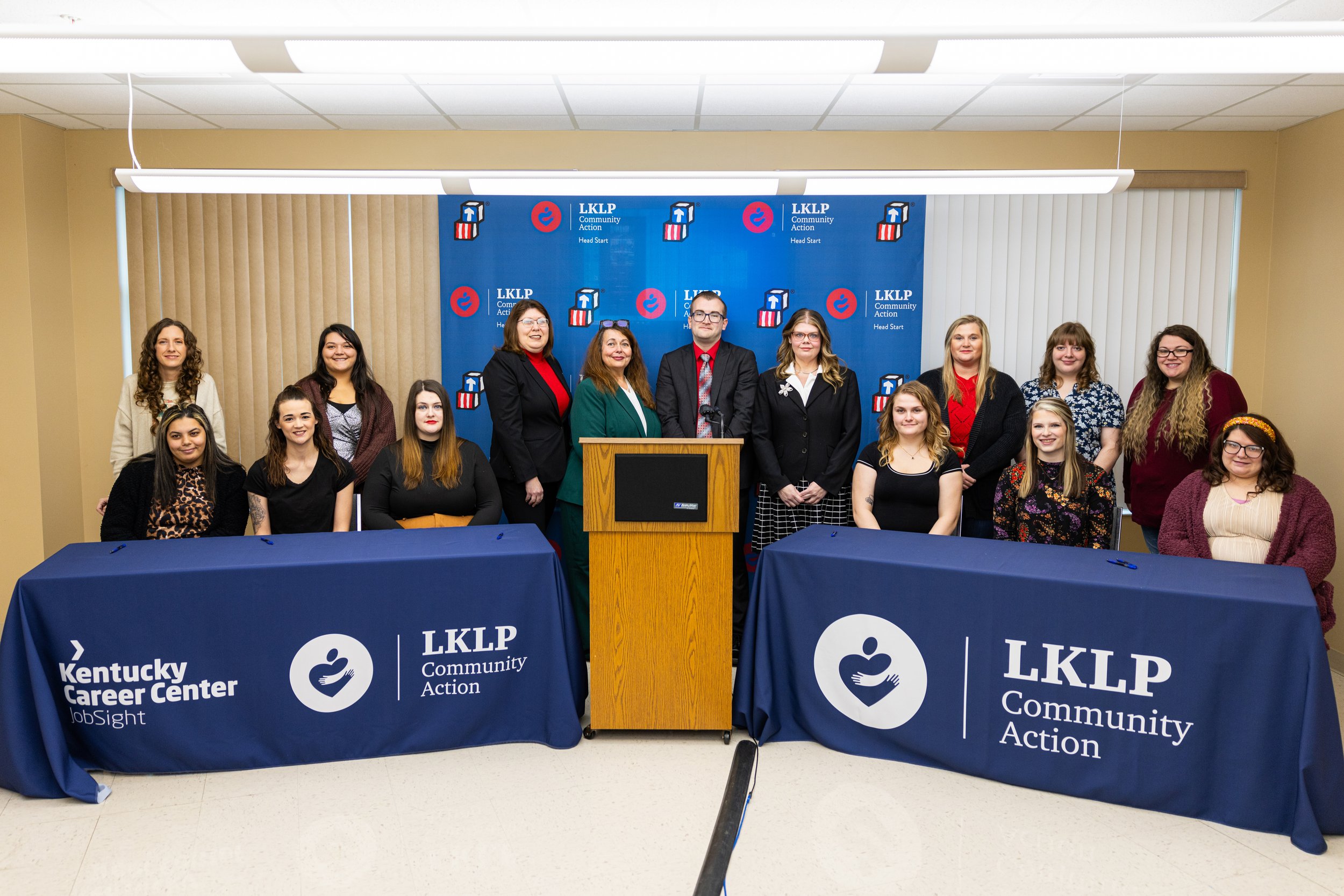 a group of people standing in front of a podium