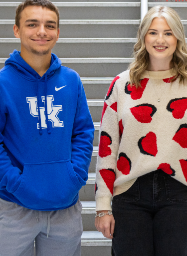 a person and person standing in front of stairs