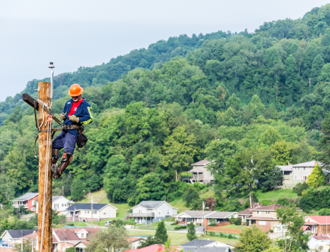 a person climbing a power line