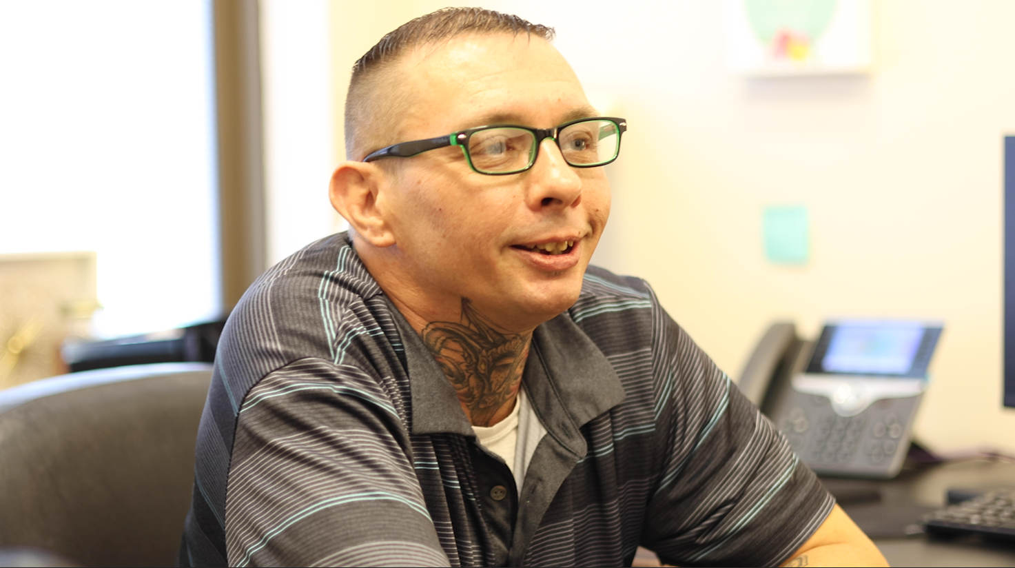 a person with a tattoo on his neck