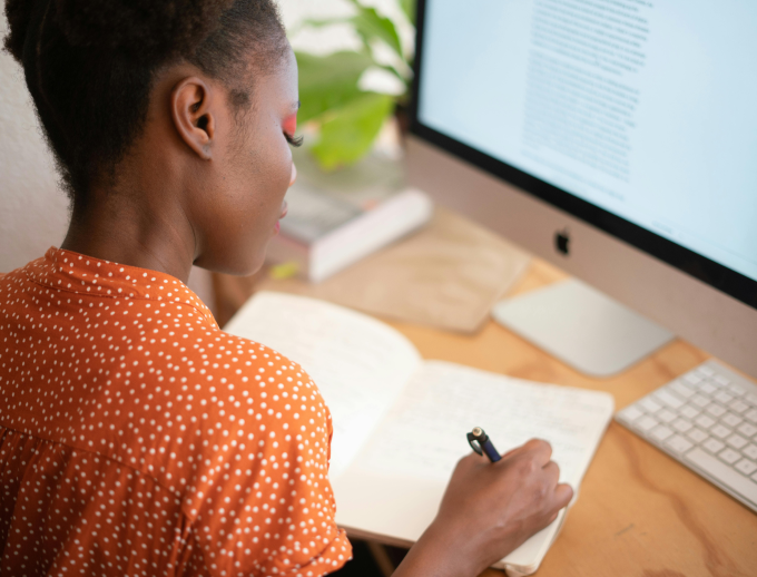 a person writing on a book