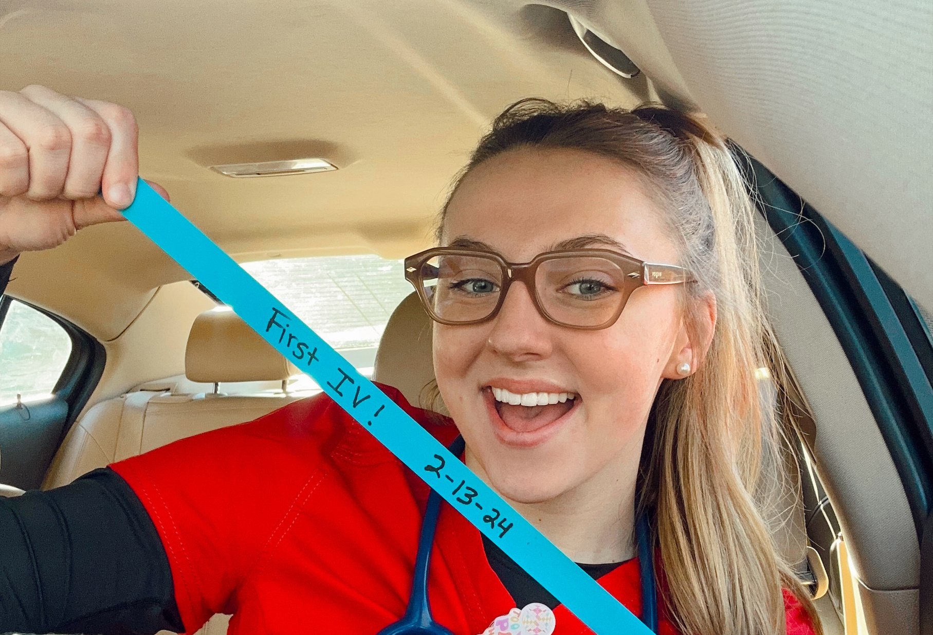 a person in a car with a blue tape